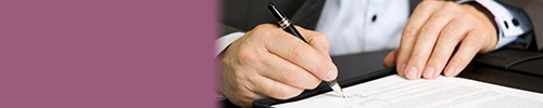 A man signing an important document.